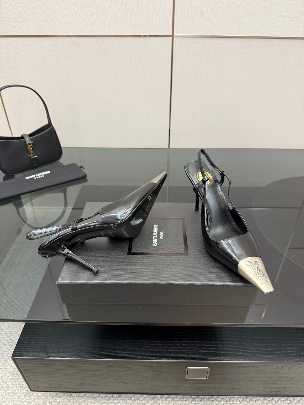 Women's YSL black pumps with stiletto heels and silver pointed toe caps, on box