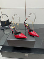 Pair of women’s red patent pointed-toe stiletto heels with gold chain slingbacks