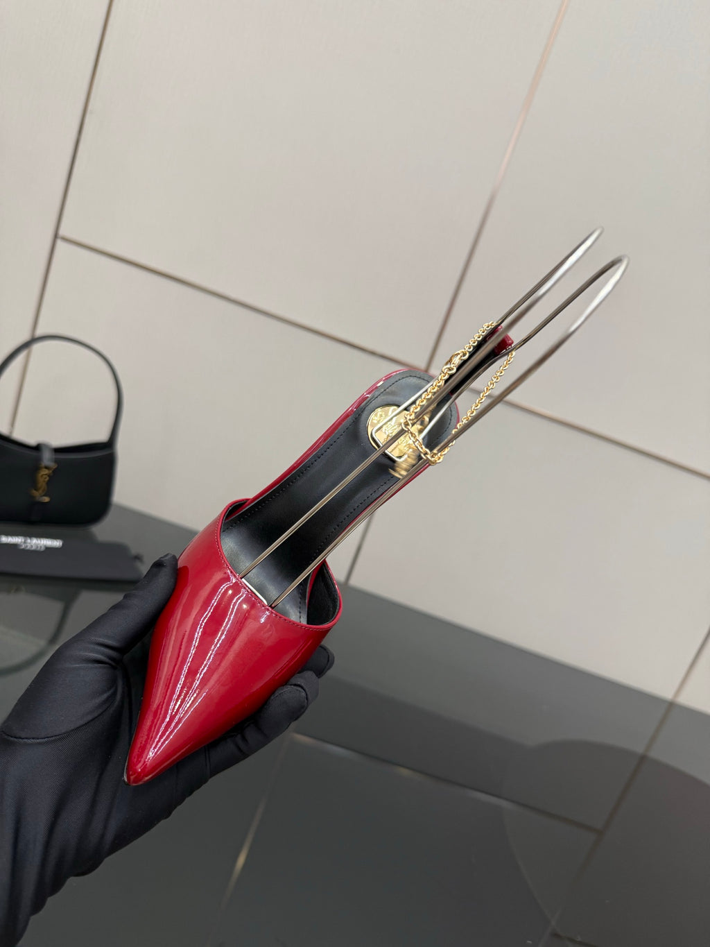 Women’s red patent pointed-toe stiletto shoe close-up, underside and heel sole