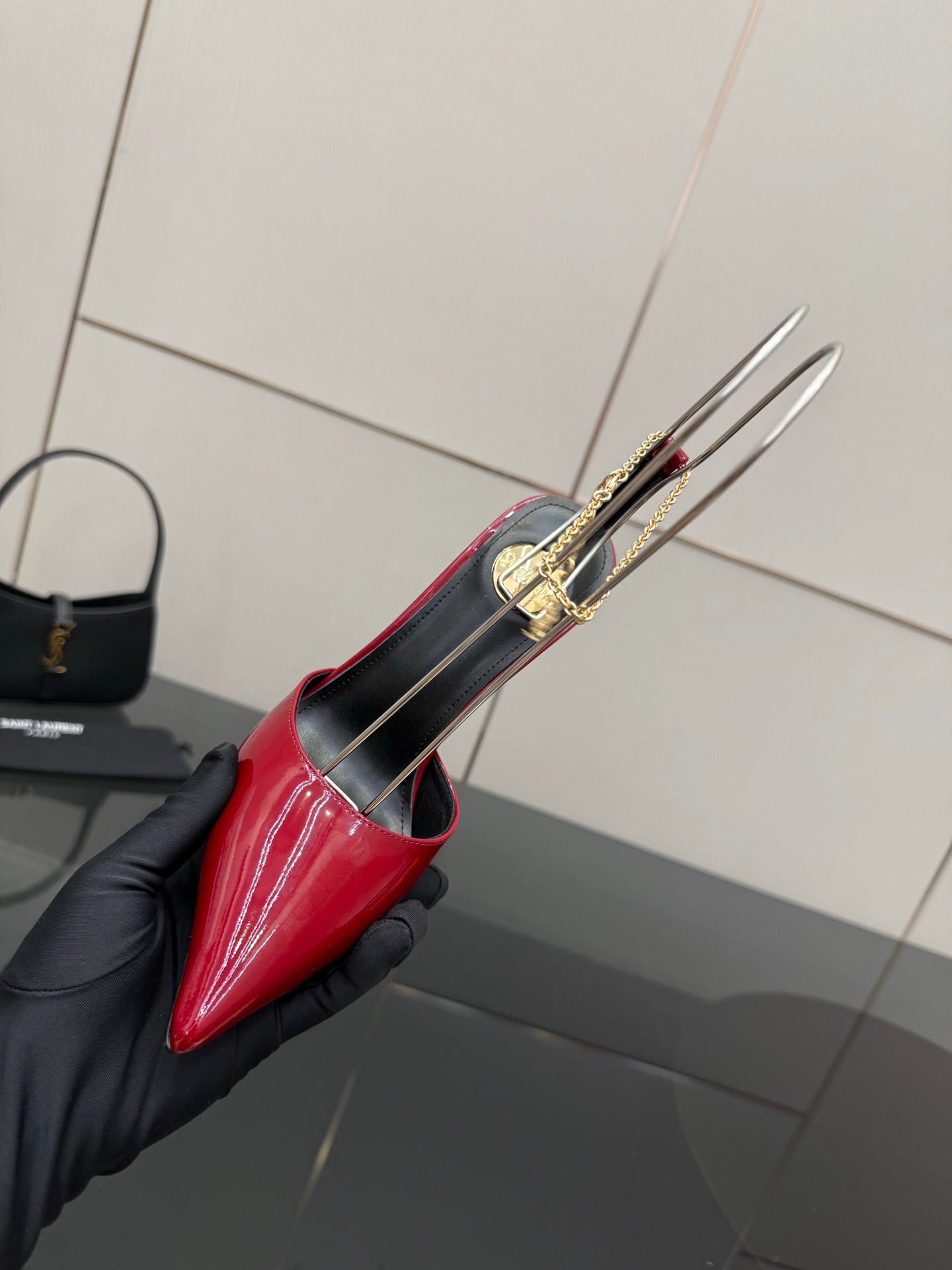 Women’s red patent pointed-toe stiletto shoe close-up, underside and heel sole
