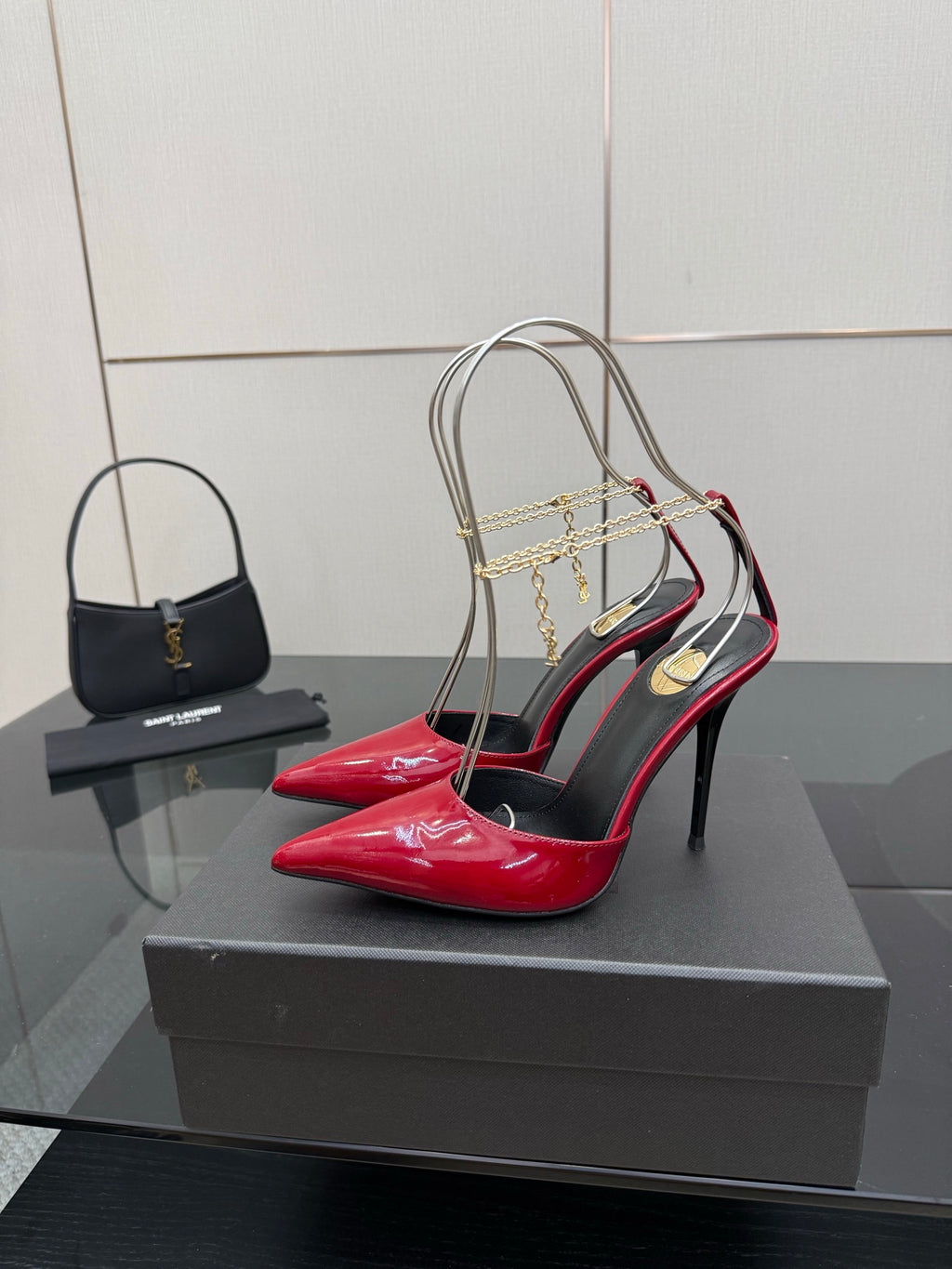 Women’s red patent pointed-toe high-heel slingback with gold chain detail