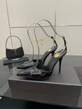 Women’s black patent leather high-heel slingback pumps with gold chain detailing