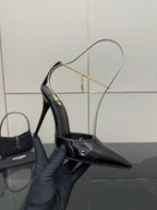 Women’s black patent leather stiletto pump on gold chain slingback strap