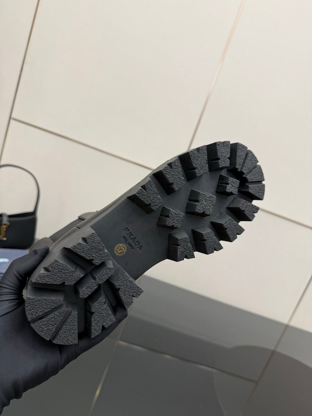 Prada black boot outsole with deep lug tread and rubber texture