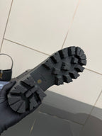 Prada black boot outsole with deep lug tread and rubber texture