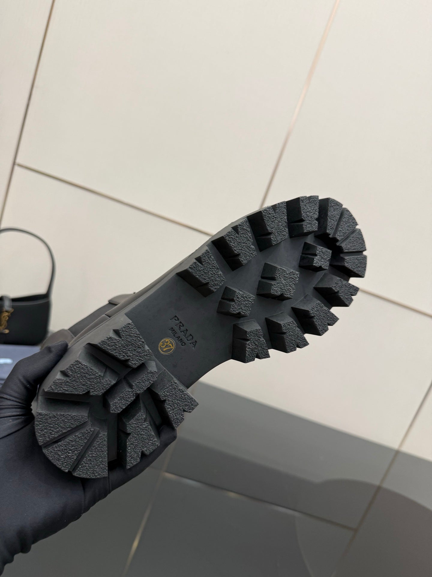 Prada black boot outsole with deep lug tread and rubber texture