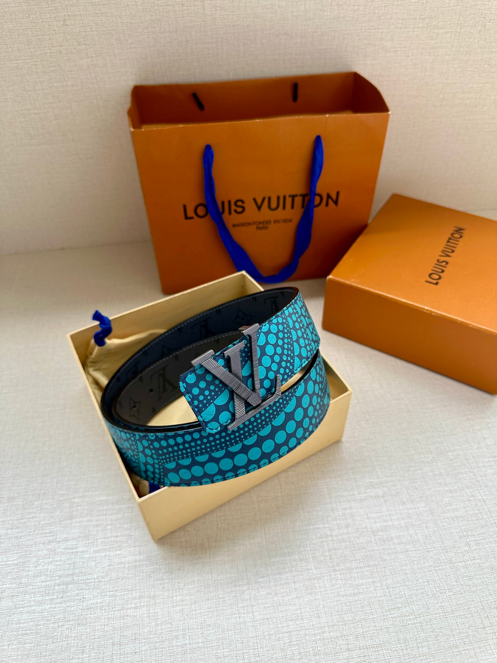 Louis Vuitton belt coiled, turquoise dot strap with gold LV buckle