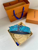 Louis Vuitton belt with turquoise dot strap, gold LV buckle, and small leather keeper