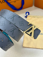 Louis Vuitton belt close-up: dark monogram strap, turquoise edge, gold LV buckle