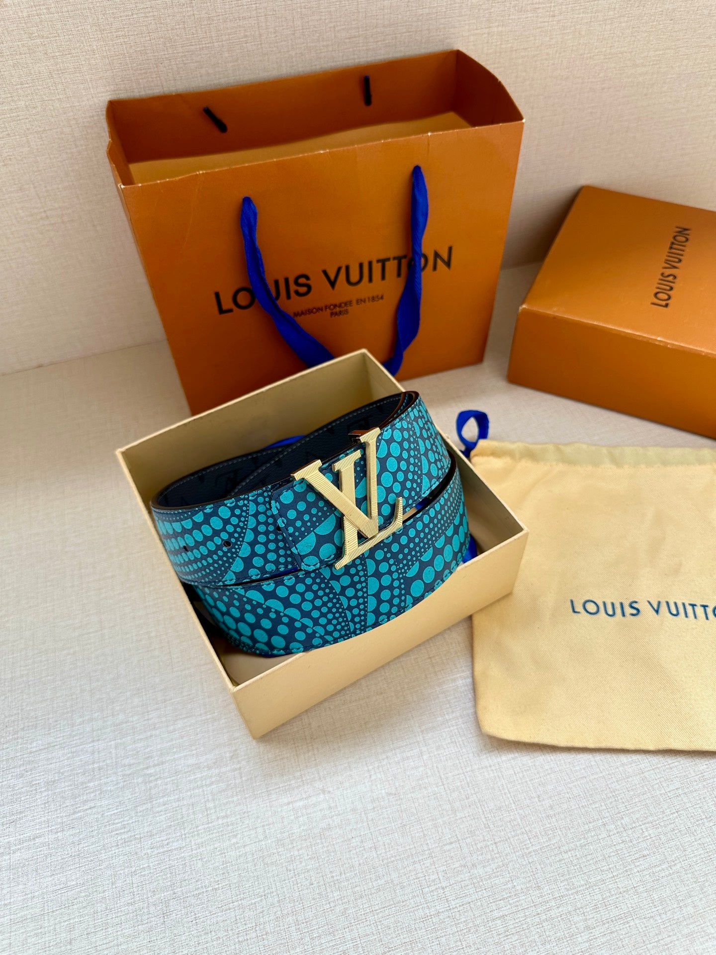 Louis Vuitton belt, turquoise dotted strap with gold-tone LV buckle