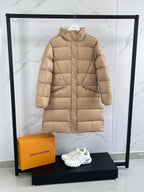 Tan long puffer coat with hood, front zip, and side pockets