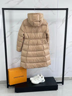 Tan long puffer coat with hood, back view, and padded button placket