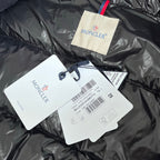 Moncler fabric label and product tags on dark gray puffer jacket collar