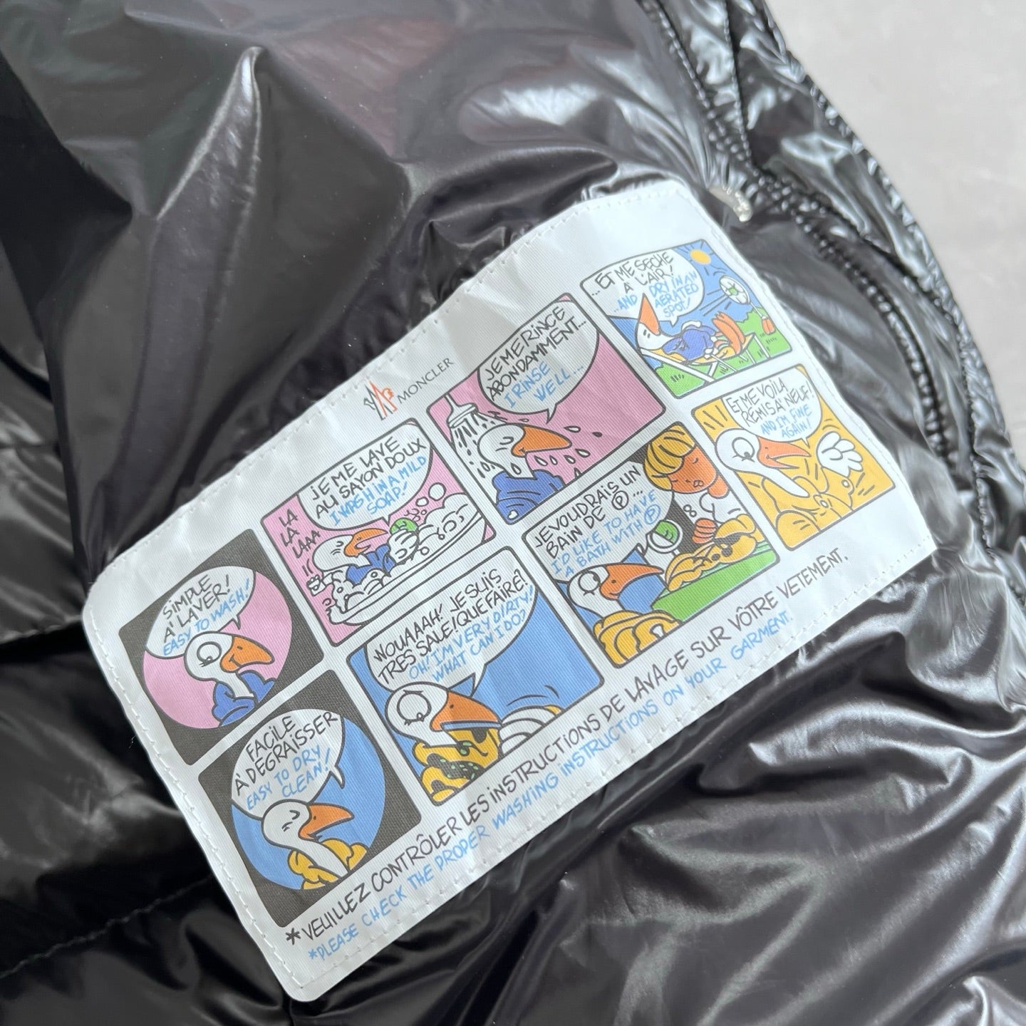Printed fabric patch with comic-style graphics on dark gray puffer jacket lining