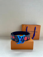 Dark navy belt with red dot pattern and blue LV buckle centered