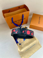 Louis Vuitton belt with buckle and red circle motif on a dark blue strap