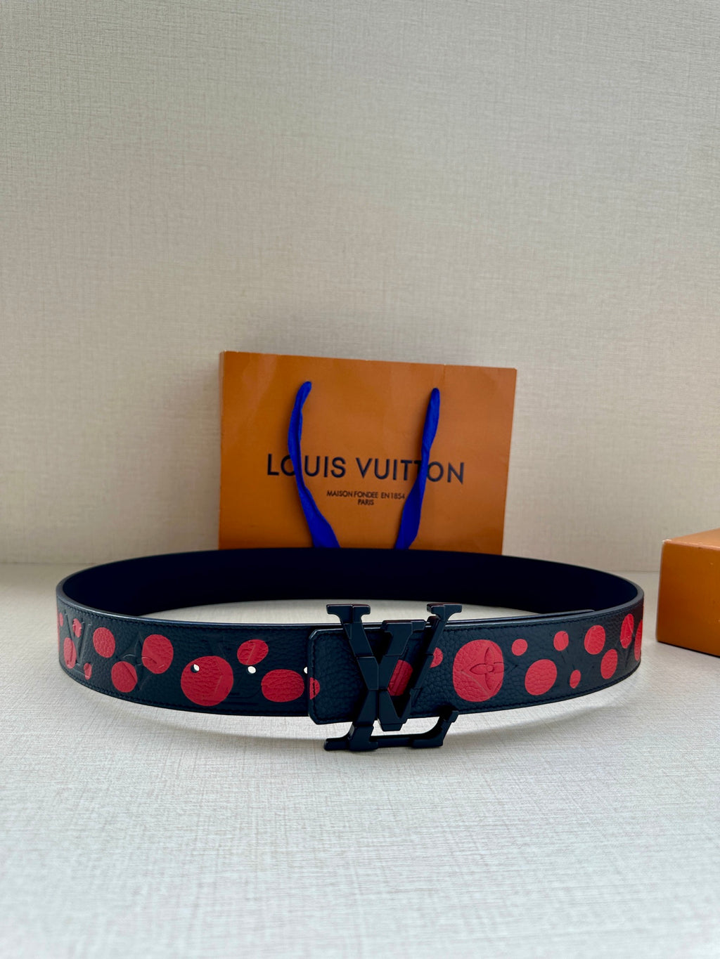 Louis Vuitton belt, dark blue with red circle pattern, silver V buckle