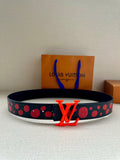 Louis Vuitton belt with dark strap and red studded dot pattern, orange LV buckle