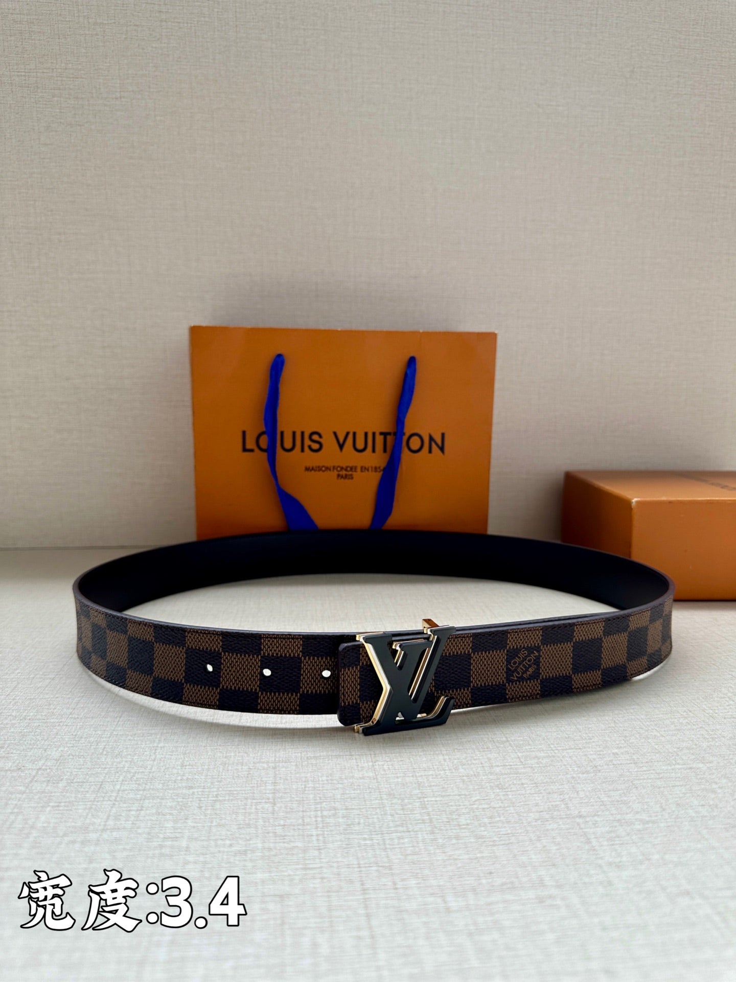 Checkered leather belt with dark buckle and LV logo centerpiece