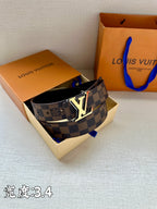 Checkered leather belt with LV logo buckle resting in gift box