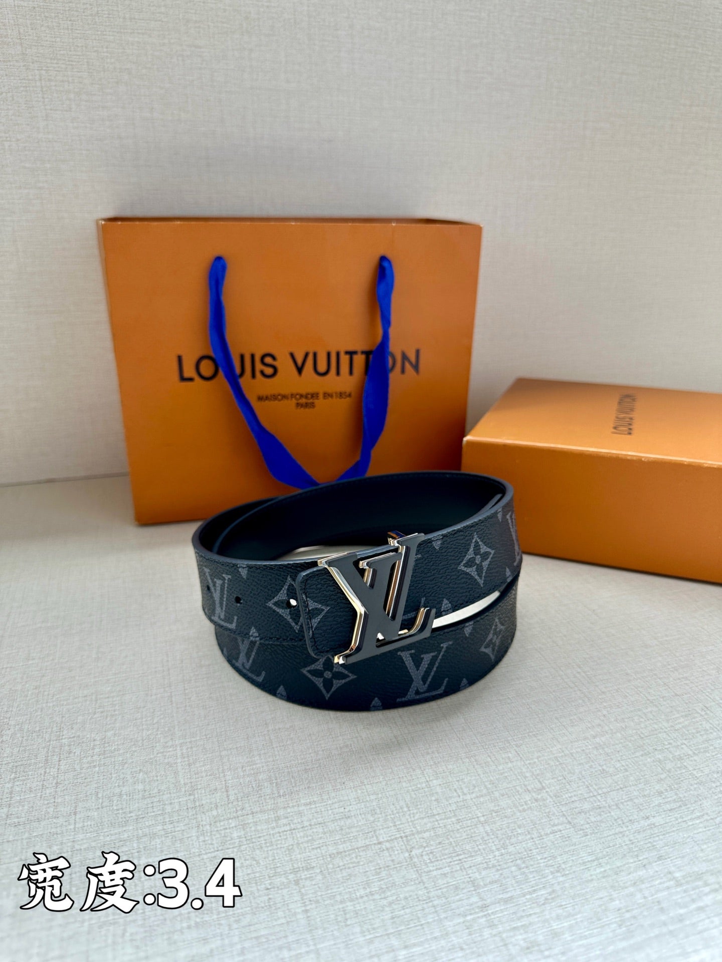 Louis Vuitton monogram belt in dark blue with gold-tone buckle on a circular strap