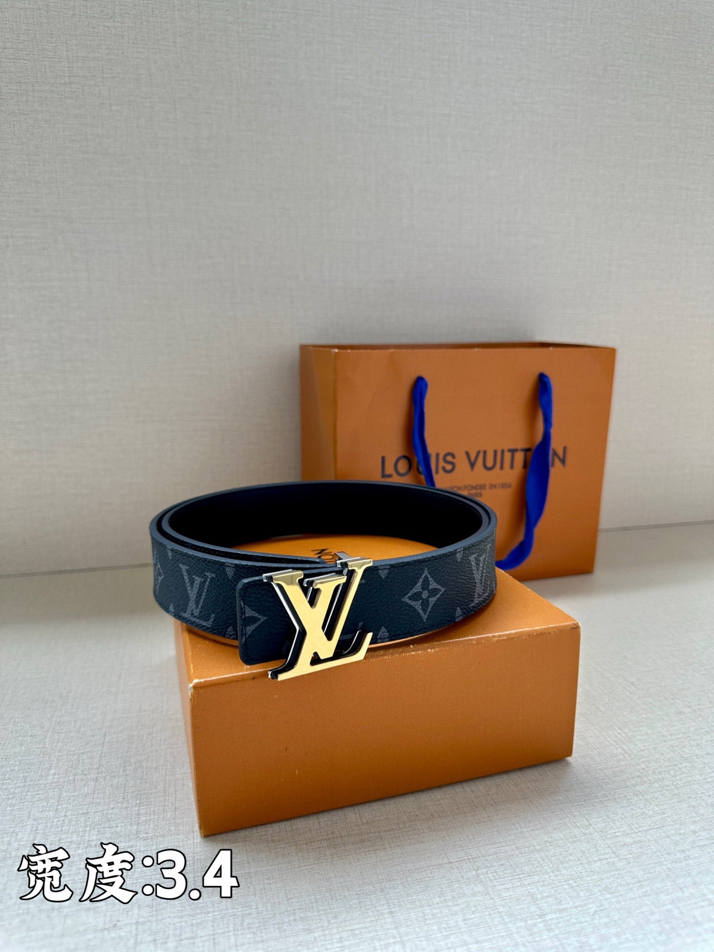Louis Vuitton dark blue monogram belt with gold-tone buckle centered on the strap