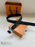 Louis Vuitton monogram belt with dark blue strap and gold buckle lying across it