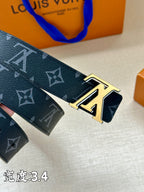 Louis Vuitton belt close-up showing dark blue monogram strap and gold buckle