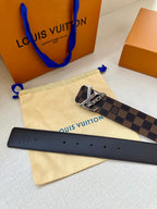 Louis Vuitton belt with dark check canvas strap, gold LV buckle, and black leather underside