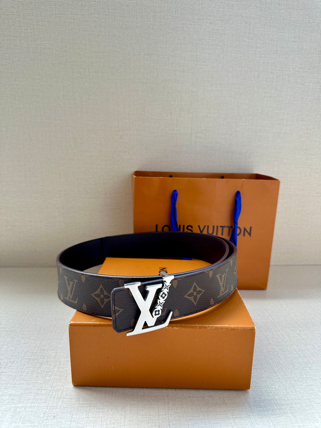 Louis Vuitton monogram belt with gold buckle, dark brown strap on boxes