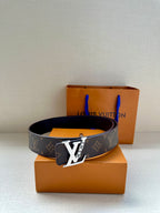 Louis Vuitton monogram belt with gold buckle, dark brown strap on boxes