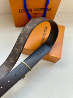 Louis Vuitton belt showing underside text and gold-tone buckle on dark strap