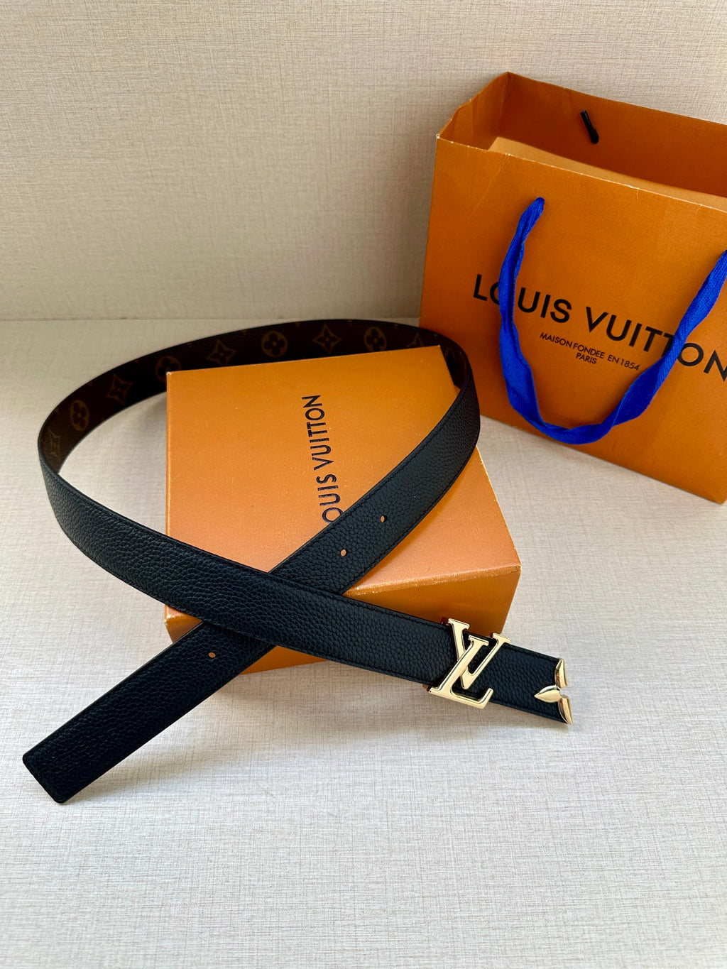 Leather belt in dark blue with gold LV buckle and long strap end detail