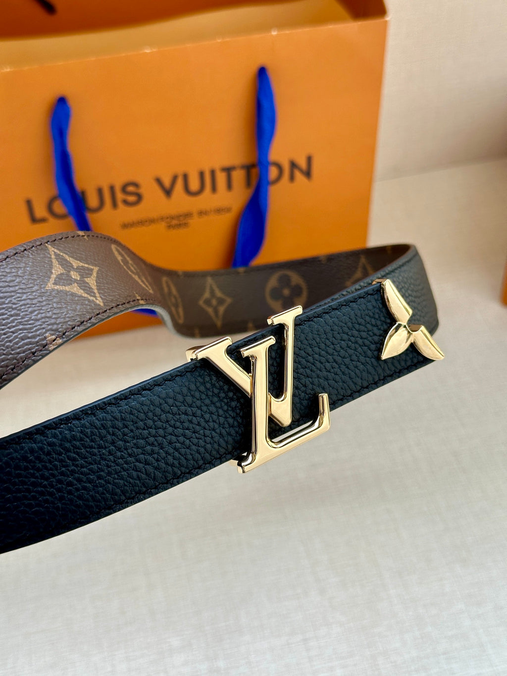 Leather belt with monogram strap and dark blue leather, gold LV buckle centerpiece