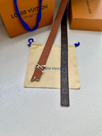 Louis Vuitton belt with dark monogram strap and gold V buckle, on a pouch