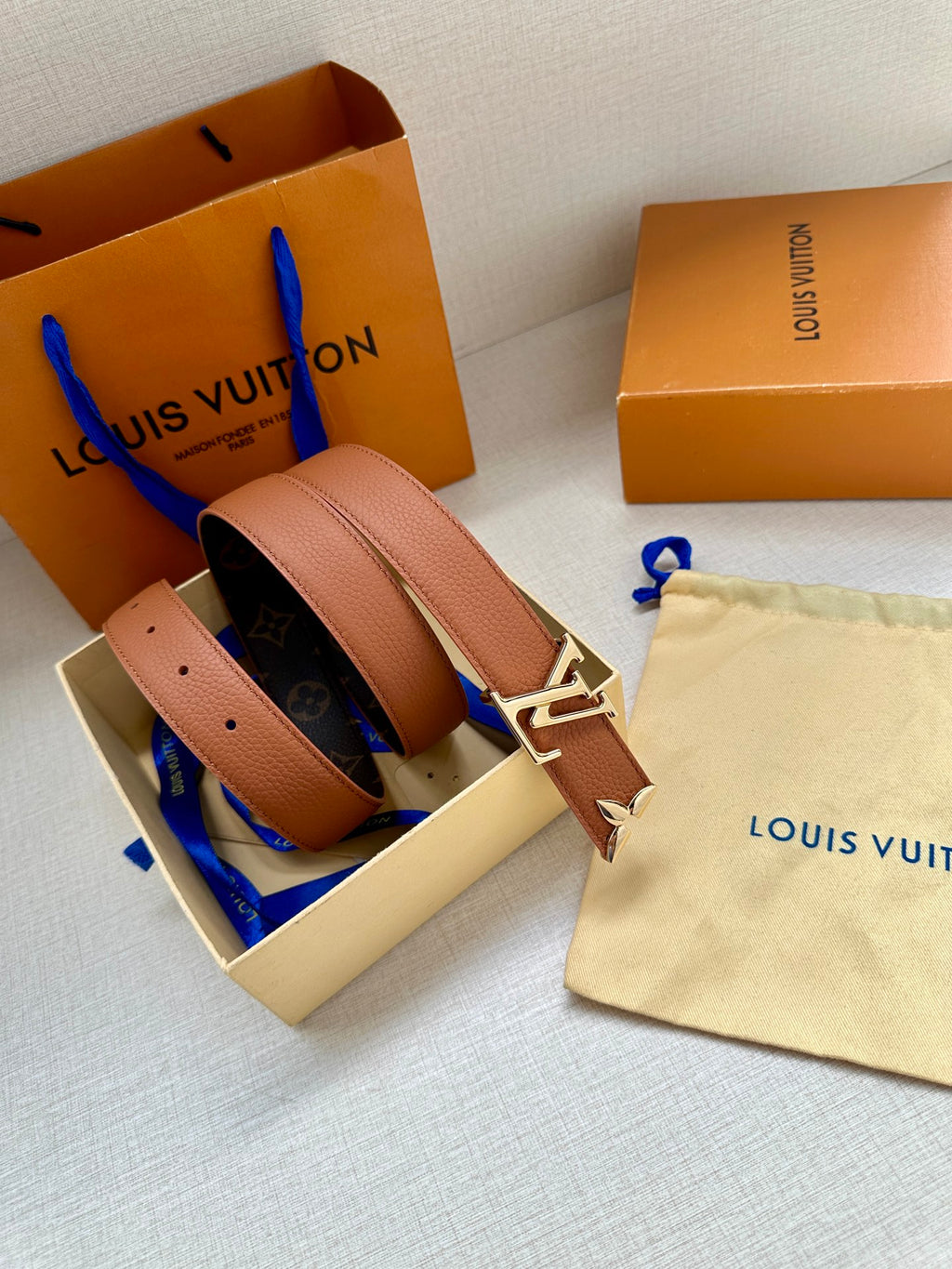 Louis Vuitton belt with light tan leather strap and gold V buckle