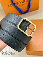 Louis Vuitton leather belt close-up, dark blue with gold-tone buckle and side slots