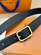Louis Vuitton belt close-up: dark blue leather with gold-tone buckle and punched holes