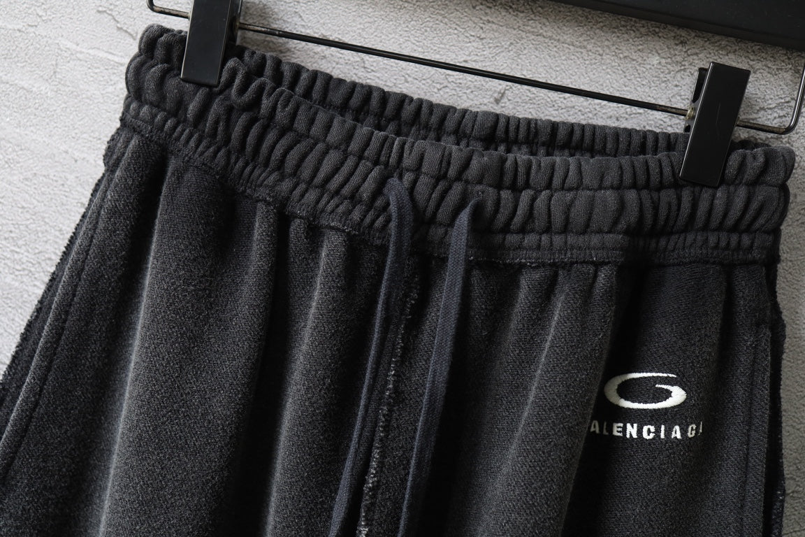 Black wide-leg pants with elastic waistband and drawstring cords