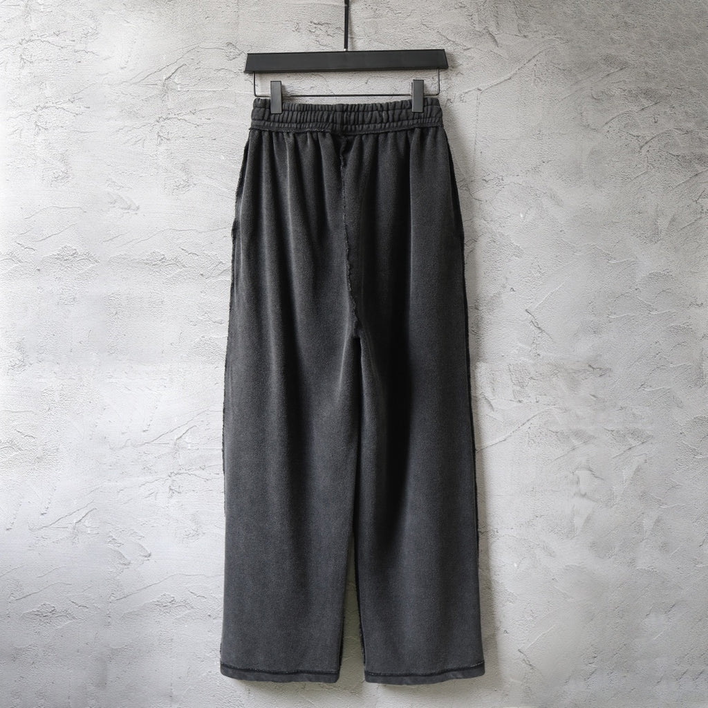 Dark wide-leg pants with elastic waistband and drawstring