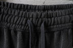 Balenciaga elastic waistband and gathered drawstring on dark pants