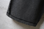 Balenciaga dark pants with cuffed hem and textured fabric