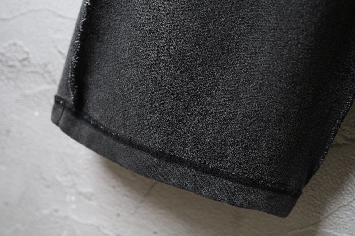 Balenciaga dark pants with cuffed hem and textured fabric
