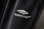 Balenciaga pants logo patch on dark fabric