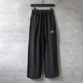 Balenciaga black drawstring wide-leg pants with logo patch on right leg.