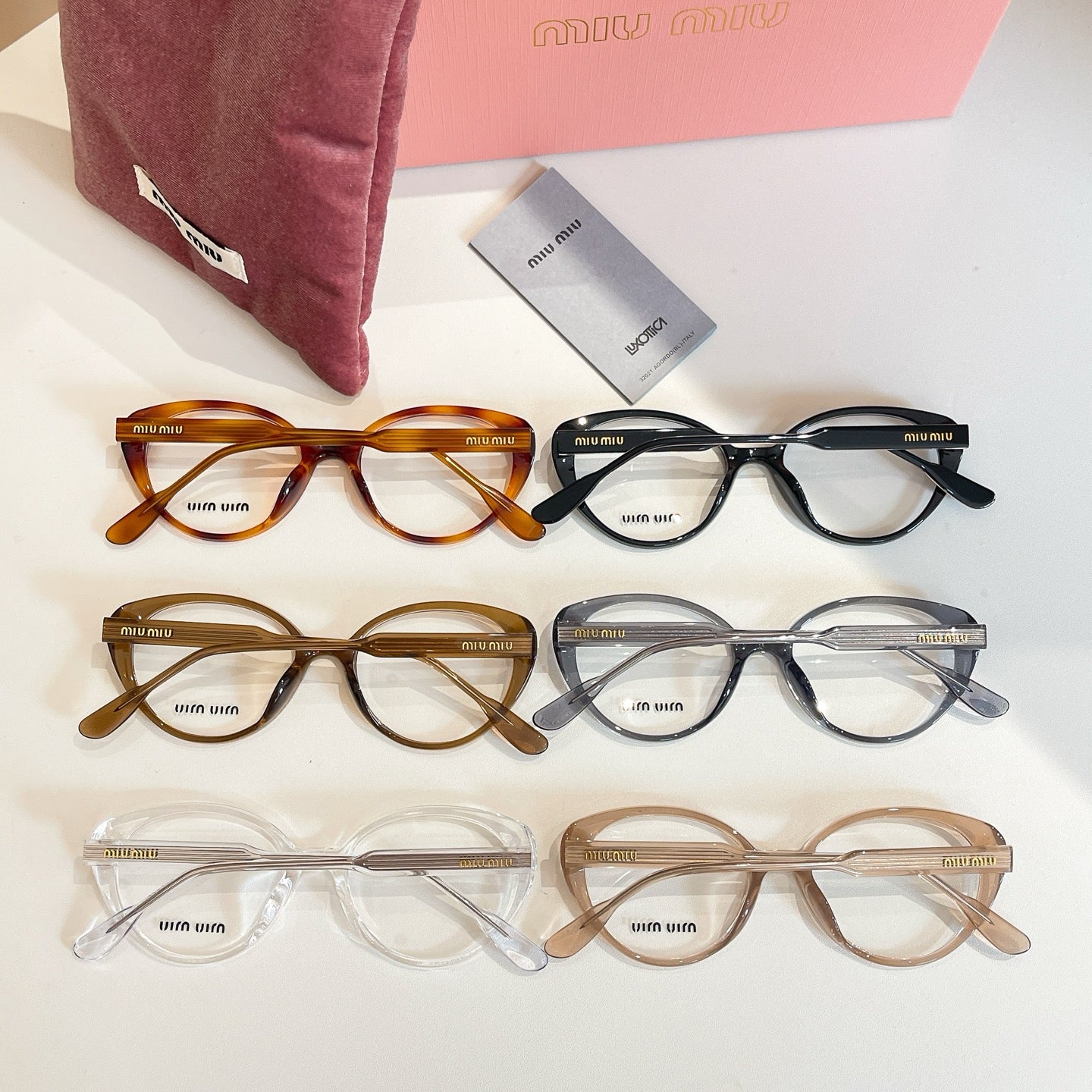 MiuMiu eyeglasses assortment with full-rim frames in amber, black, and clear