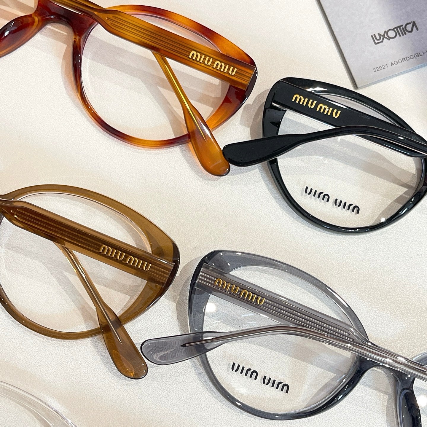 MiuMiu eyeglasses close-up with brown, black, and clear full-rim frames