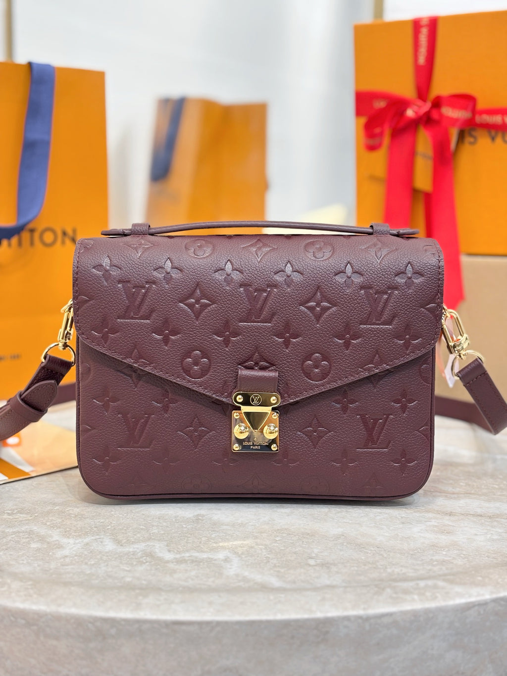 Louis Vuitton mini flap shoulder bag, dark plum monogram, gold front clasp.