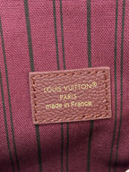 Louis Vuitton mini flap shoulder bag label, dark plum fabric with brand text.