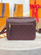Louis Vuitton mini flap shoulder bag, dark plum monogram, front zip pocket, gold hardware.
